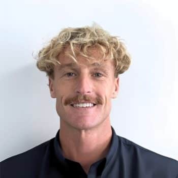 Portrait of David Pearce, Consulting Psychologist at Mind-Care Mental Health Services, wearing a dark collared shirt against a plain white background.